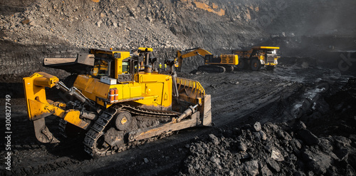 Open mine minerals coal. Workflow using transport, excavator, large dump truck. Level soil after explosion