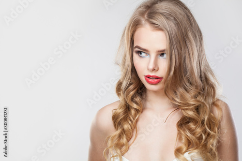 Beautiful blonde woman looking a side on white background