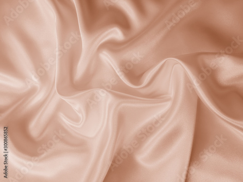 Beautiful smooth elegant wavy beige / light brown satin silk luxury cloth fabric texture, abstract background design. Copy space.