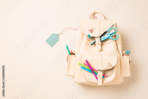 White backpack with school supplies and blank tag - education