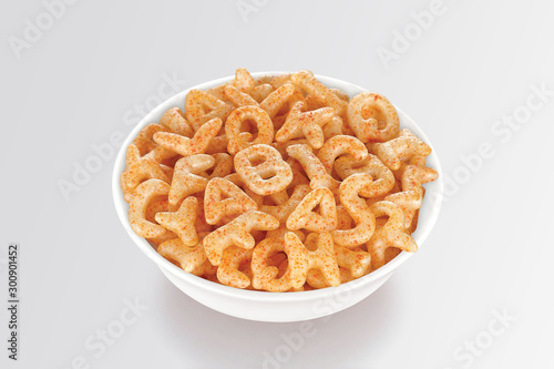 Fried and Spicy Alphabet, ABCD, A-B-C-D, Snacks or Fryums (Snacks Pellets) served in a white bowl. selective focus - Image