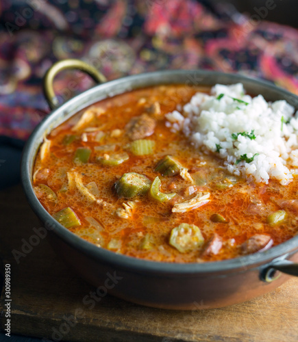 Close up view of chicken gumbo with a scoop of rice. 