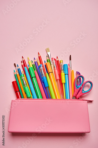 Group of school supplies and books on table