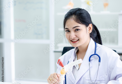Medical physician doctor woman over blue clinic background. or lab background