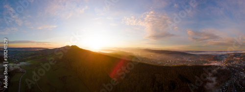 aerial panorama of the sun rising on a misty morning