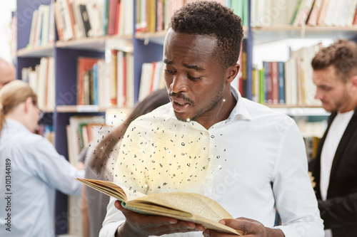 African man looks in awe at book