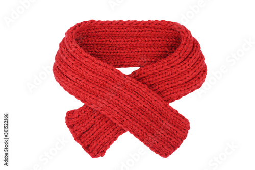 Small red knitted scarf isolated on a white background. Handmade woolen neckwear. Closeup. Copy space