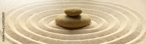 zen garden meditation stone background with stones and lines in sand for relaxation balance and harmony spirituality or spa wellness