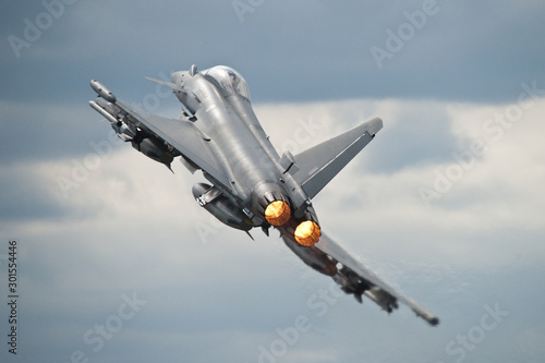 An RAF Typhoon takes off fully loaded with weapons on its wings to perform a display at an Airshow