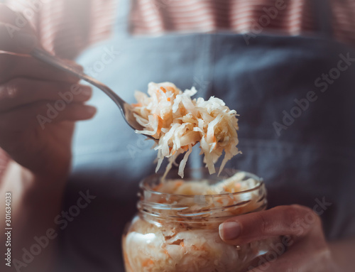 Closeup sauerkraut holds on a fork cook.
