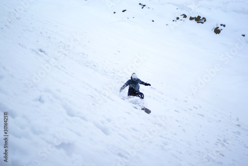 Snowboarder manoeuvres on the downhill snow - Apatity mountain Russia