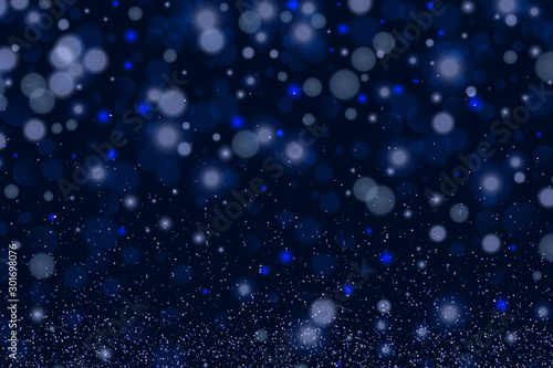 Blue bokeh background. Christmas glowing lights with sparkles. Holiday decorative effect.