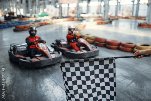Two kart racers on start line, checkered flag