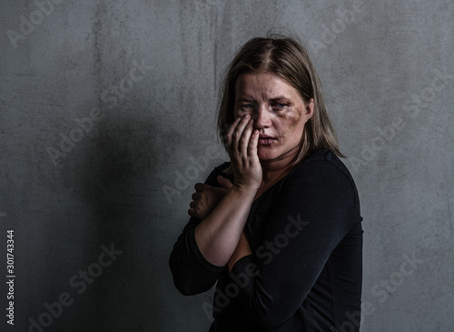 Depressed woman victim of domestic violence and abuse. Empty space for text