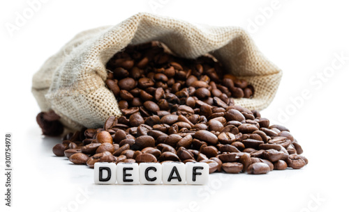 Roasted coffee beans scattered out of the bag. Concept of decaf coffee