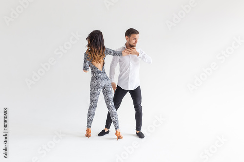 Social dance, kizomba, tango, salsa, people concept - beautiful couple dancing bachata on white background with copy space