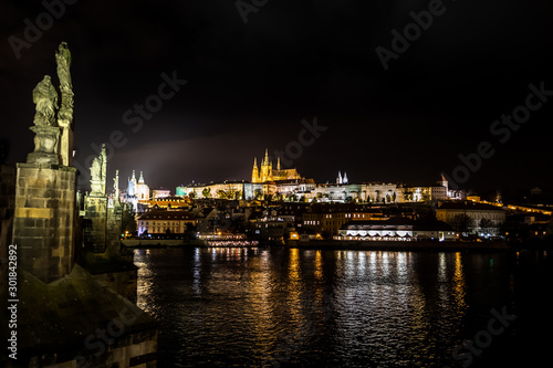 Illuminated Saint Vitus Cathedral, Hradcany Castle And River Moldova In The Night In Prague In The Czech Republic