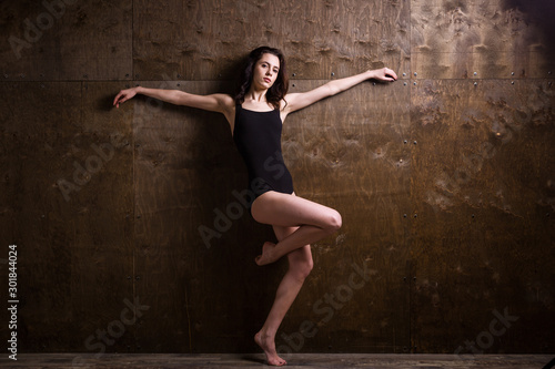 Young woman dancer. Young woman modern dance. Skill ballet dancer posing. dancer posing near the wall. full length portrait of a flexible young woman posing near the wall. Dancer, flexibility