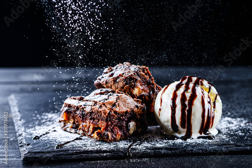 hot chocolate brownie dessert ice cream ball and slice of chocolate cake