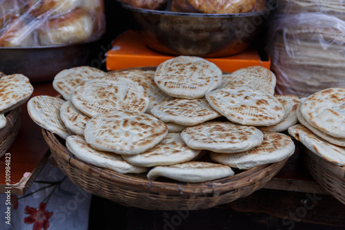 LHASA, TIBET / CHINA - August 1, 2019: Bowl with traditional tibetan flatbread - known as Balep Korkun. Similar to Naan. Main ingredients of the flat bread are barley flour, water and baking powder.