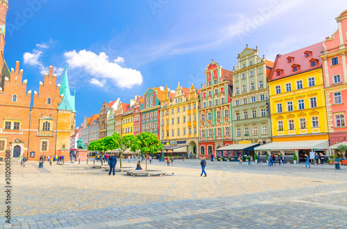 Row of colorful buildings with multicolored facade and Old Town Hall building on cobblestone Rynek Market Square in old town historical city centre of Wroclaw, Poland
