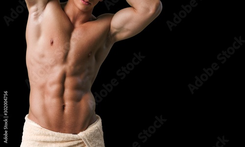 Close up of perfect male body isolated on black background with copy space