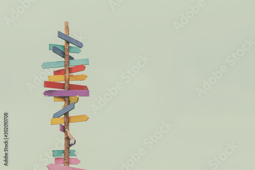 Retro styled image of colorful wooden direction arrow signs