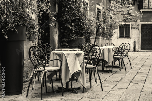 Tables and chairs in a small square in Venice