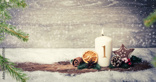4th advent Christmas Eve with candle and number and snowy landscape