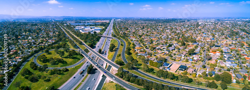 Scenic aerial panorama of highway interchange in greater Melbourne suburbs on sunny day