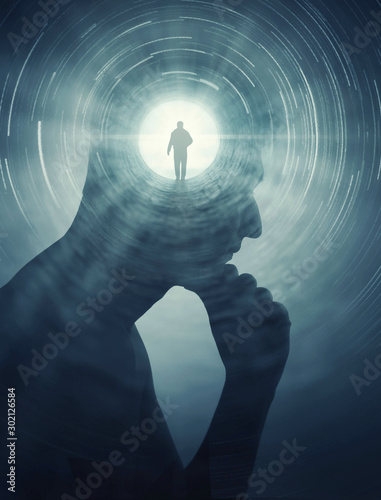 A silhouete of a man with rays of light emanating from the brain as a symbol of the power of thinking. Concept on the topic of psychiatry (bipolar disorder, schizophrenia), psychology etc..