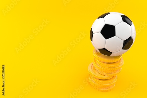 Soccer ball with stack of coins