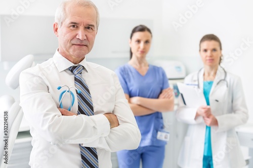 Medical personel doctor, nurse and dentist standing in clinic