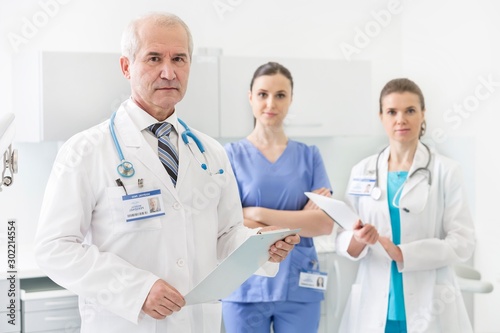 Medical personel doctor, nurse and dentist standing in clinic