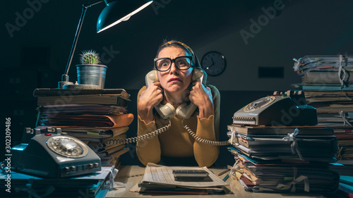 Frustrated secretary working overtime at night