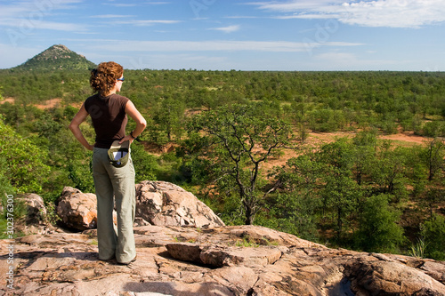 Tourist on a safari in savanna of the Kruger national park