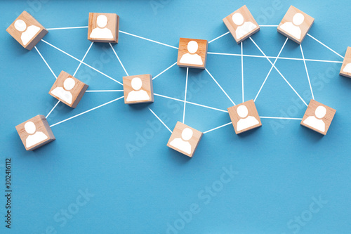 Wooden blocks connected together on a blue background. Teamwork concept