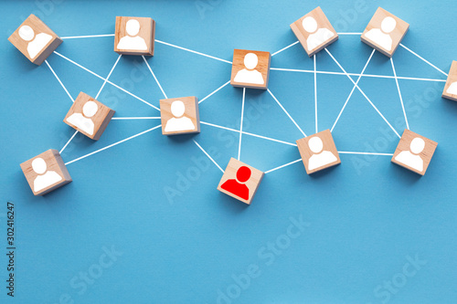 Wooden blocks connected together on a blue background. Teamwork concept