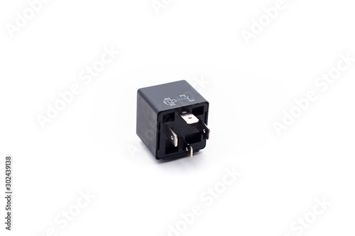 Car electric relay switch on isolated white background. Car electric spare part.