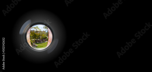 View through peephole in door looking out to entry