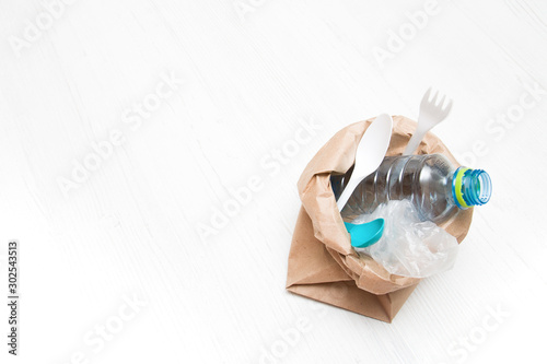 plastic trash in a paper bag, eco friendly concept