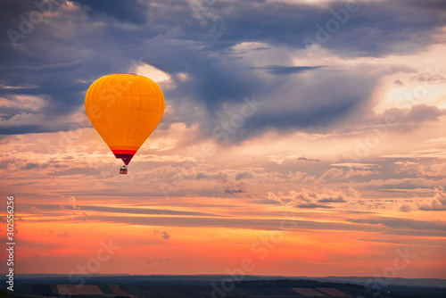 Hot Air Baloon Flying with Beautiful Colorful Dramatic Sky at Sunset