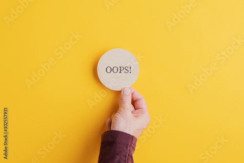 Oops sign on wooden cut circle
