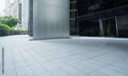 Empty ground in front of modern buildings .