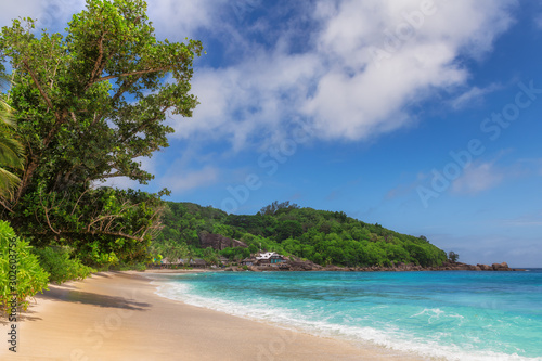 Tropical sunny beach and turquoise sea in Anse Takamaka beach, Seychelles. 