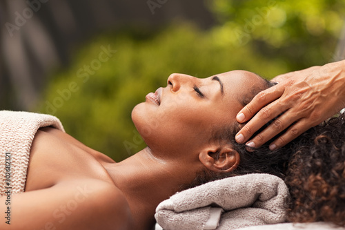 Beautiful african woman relaxing with face massage