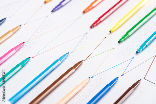 colorful felt-tip pens on white background with connected drawn lines, connection and communication concept