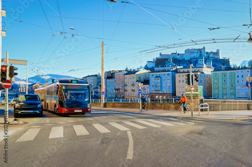 Cityscape with car and bus on street road at Salzburg Castle in Austria. Traffic in Mozart city in Europe at winter. Panorama and landmark during Christmas. View of old Austrian town of Salzburgerland