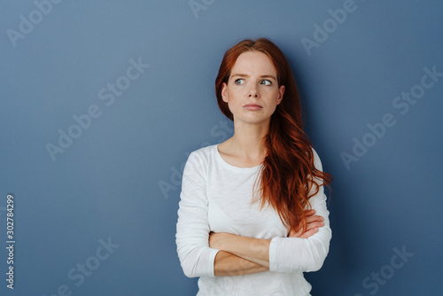 Thoughtful jealous young woman looking aside