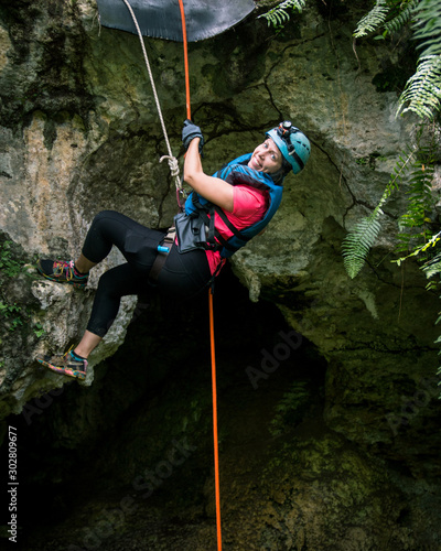 A female traveler goes rappelling into a cave in Puerto Rico